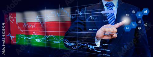 Businessman touching data analytics process system with KPI financial charts, dashboard of stock and marketing on virtual interface. With Oman flag in background. © TexBr