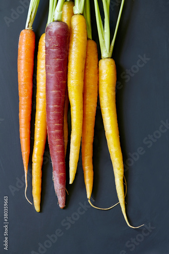 Stack of carrots on black background photo