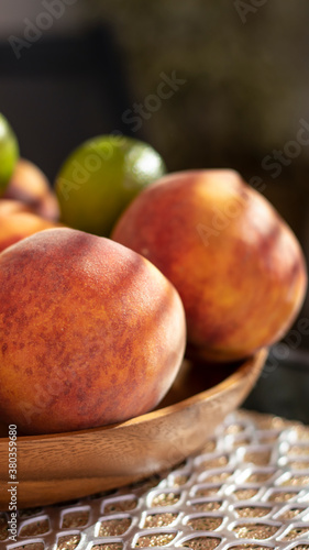 Fruit in a wooden bowl. Pea...