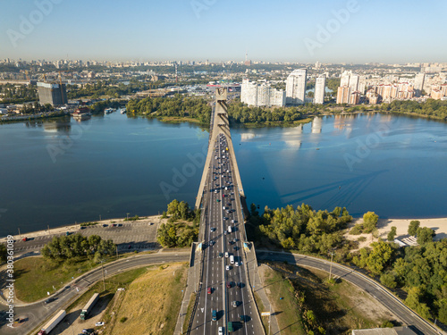 Aerial drone view. Automobile North Bridge in Kiev across the Dnieper River. Sunny day. © Sergey