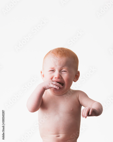 Studio shot of naked baby boy (18-23 months) crying