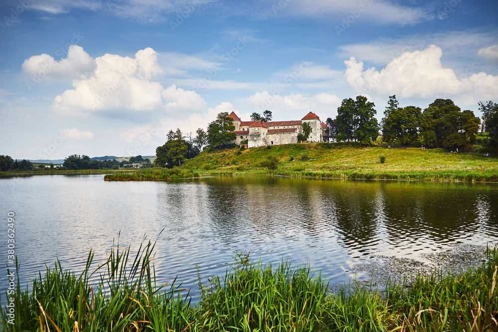 Ancient Svirzh castle with lake and trees in Lviv region Ancient Svirzh castle with lake and trees in Lviv region