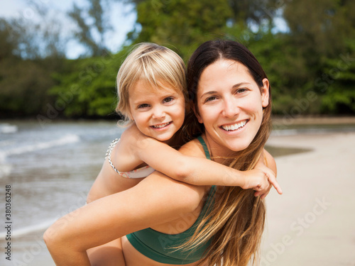 Mother with daughter (2-3) on beach photo