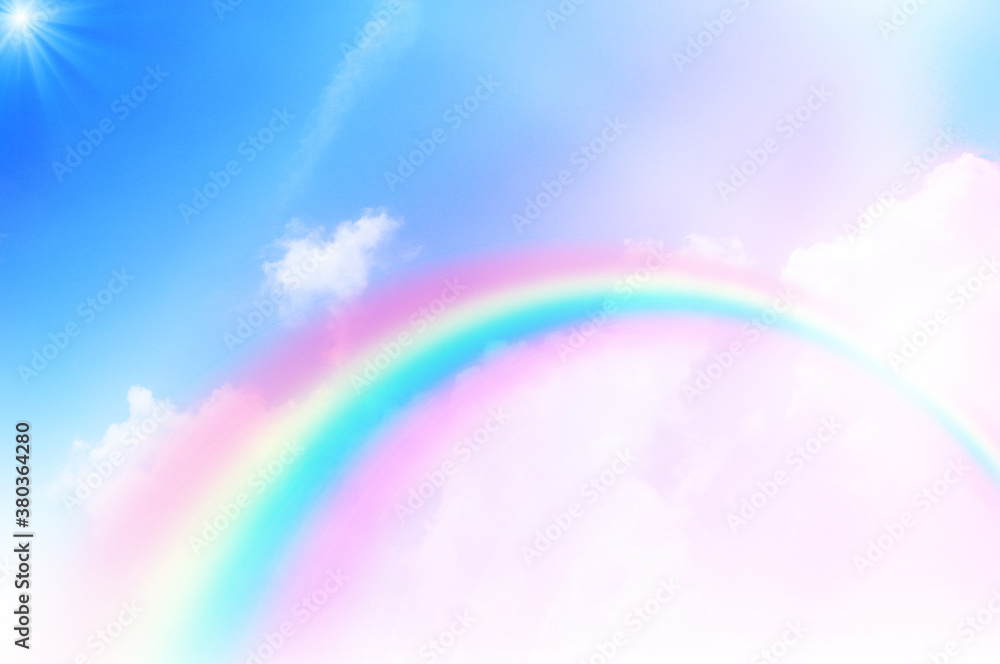 The Rainbow sky is Colorful sky with Soft clouds and a rainbow crossing. Fantasy magical sunny sky pastel background is fluffy white cloud. Freedom wallpaper concept. Sweet color dream.