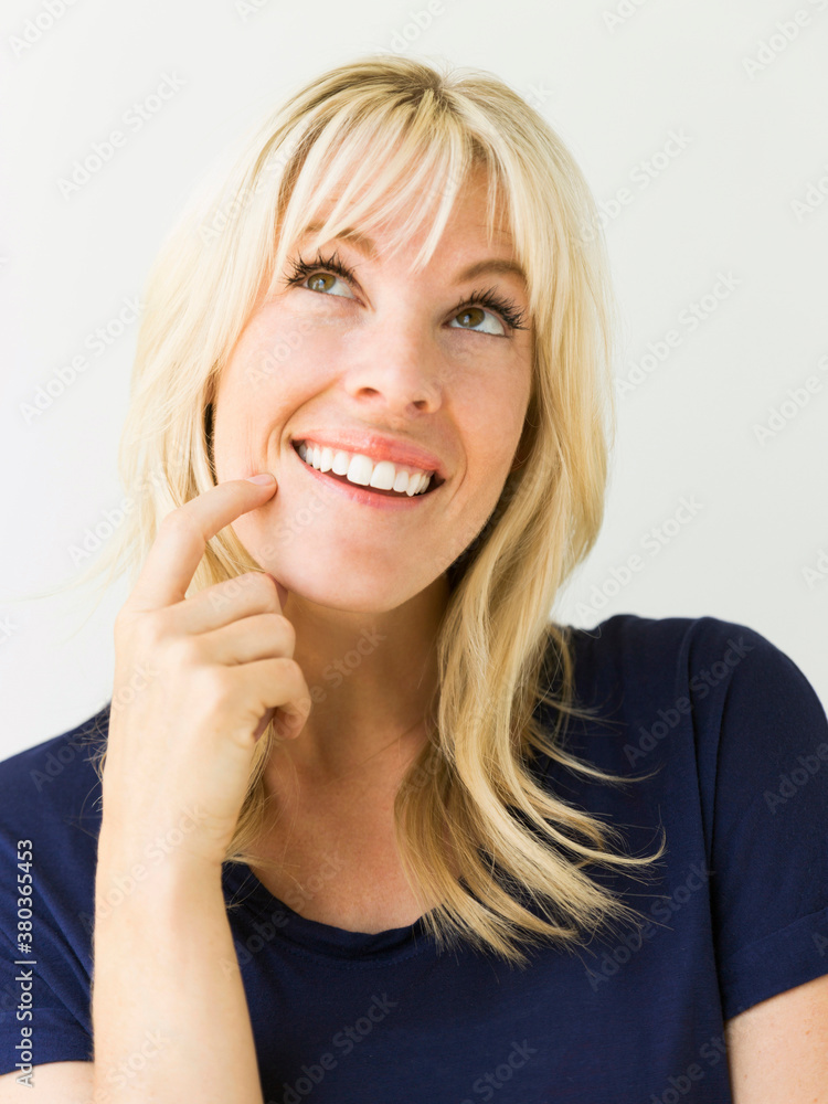 Studio portrait of blonde woman looking up Studio portrait of blonde woman looking up