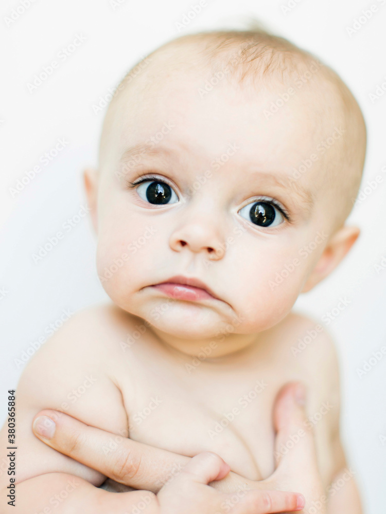 Baby boy (6-11 months) held by adult Baby boy (6-11 months) held by adult