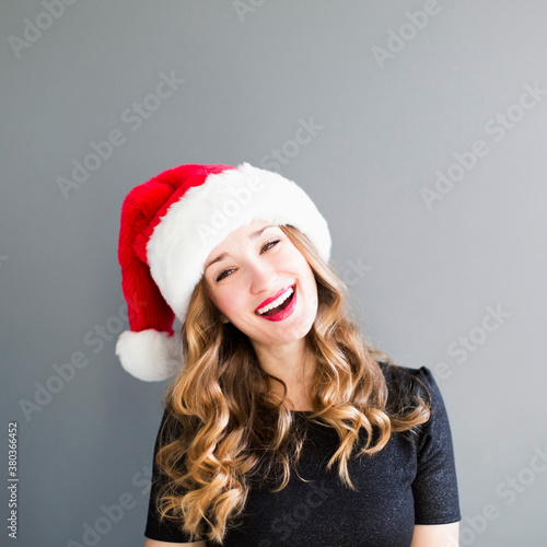 Studio portrait of woman wearing Santa hat photo