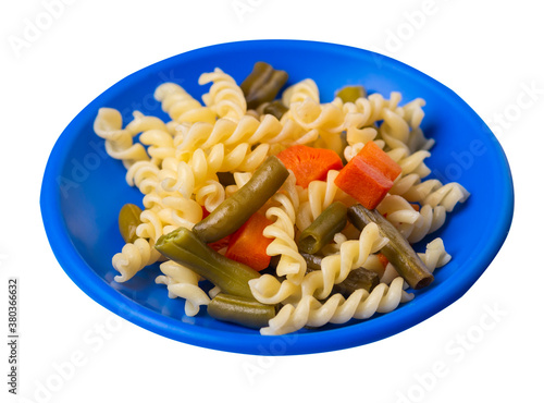 pasta with green beans with garlicand carrots on a plate isolated on a white background. Mediterranean Kitchen . photo