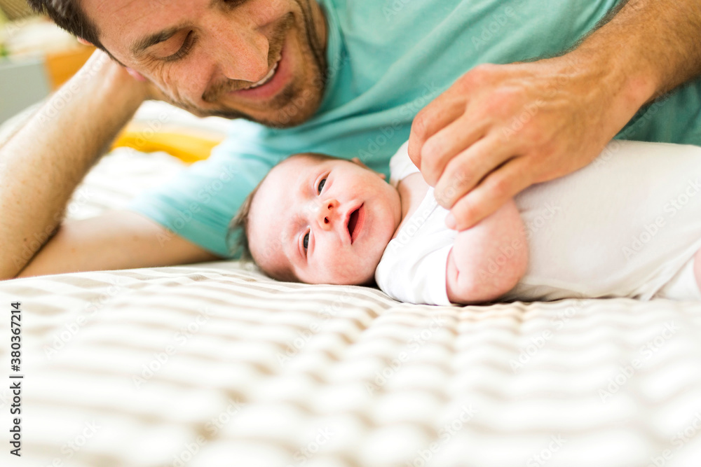 Father with baby boy (6-11 months) on bed Father with baby boy (6-11 months) on bed