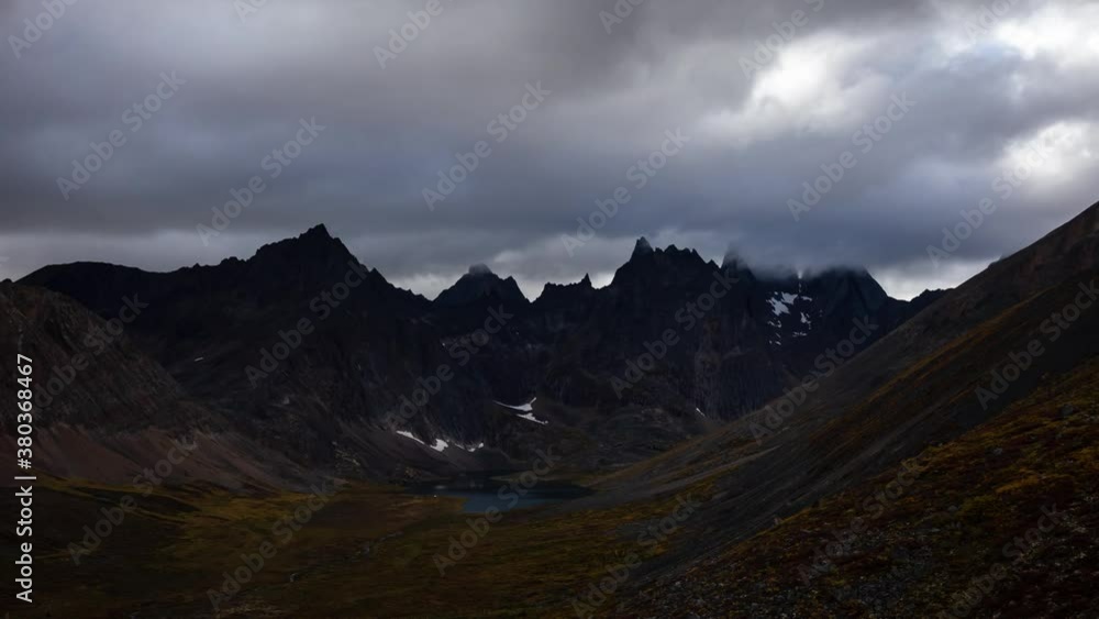 Grizzly Lake in Tombstone Territorial Park, Yukon, Canada. Cloudy morning Timelapse. Snow with Autumn Colors. Canadian Rocky Mountain Landscape. Colorful and Vibrant. Aerial View. Pan Up Grizzly Lake in Tombstone Territorial Park, Yukon, Canada. Cloudy morning Timelapse. Snow with Autumn Colors. Canadian Rocky Mountain Landscape. Colorful and Vibrant. Aerial View. Pan Up