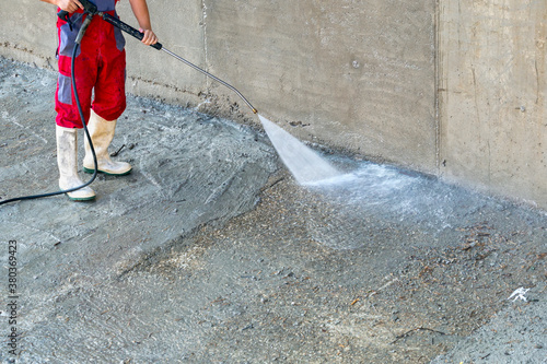 Outdoor dirty concrete cleaning with high pressure water photo