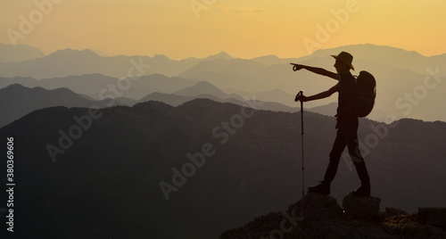silhouette of a person standing on a mountain