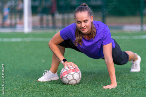 Fit healthy young woman posing with soccer ball © kolotype