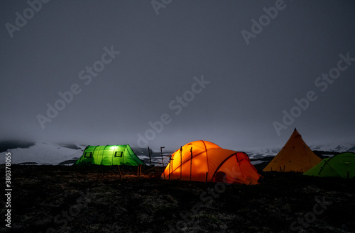 a tent of geologists glowing in the night in the mountains of the Kamchatka peninsula on the Bolshoi Semyachik volcano photo