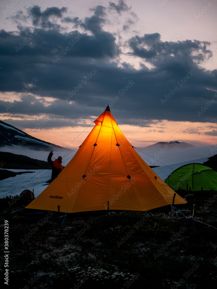 a tent of geologists glowing in the night in the mountains of the Kamchatka peninsula on the Bolshoi Semyachik volcano