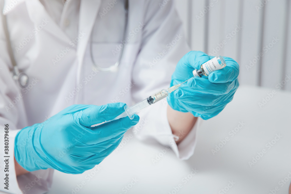 Doctor or researcher load covid-19 vaccine into syringe. Researchers are inventing vaccines to treat COVID-19 virus. Doctor or researcher load covid-19 vaccine into syringe. Researchers are inventing vaccines to treat COVID-19 virus.