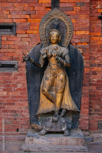 An old brass metal statue inside a Durbar Square courtyard in Patan Durbar Square.