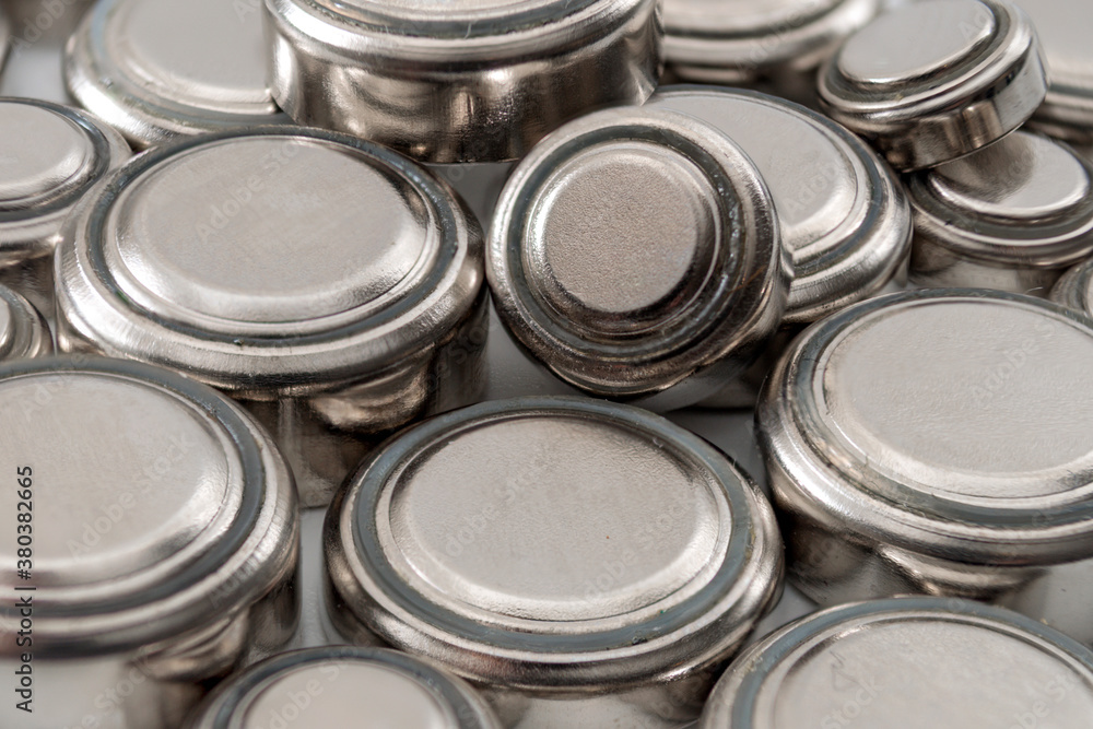 Watch repair and watchmaker replacing the battery concept with macro close up photograph of a heap of lithium button cell batteries