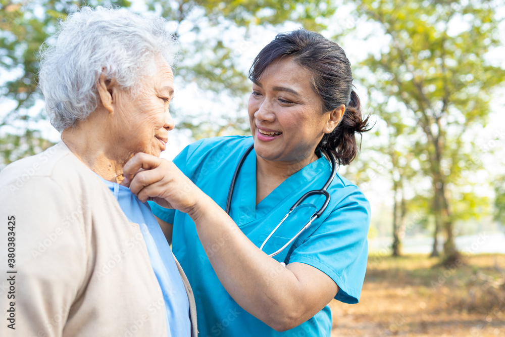 Doctor help and care Asian senior or elderly old lady woman walking at park in happy fresh holiday. Doctor help and care Asian senior or elderly old lady woman walking at park in happy fresh holiday.