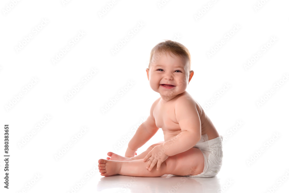 Smiling baby sitting on floor over white copyspace Smiling baby sitting on floor over white copyspace