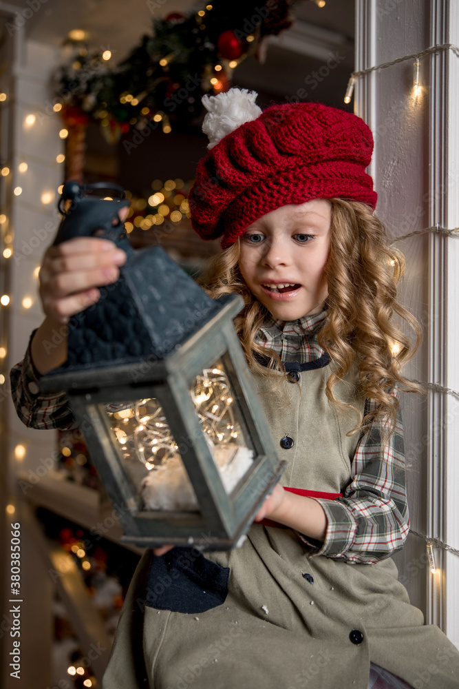 little girl admires the garland she holds in her hands little girl admires the garland she holds in her hands