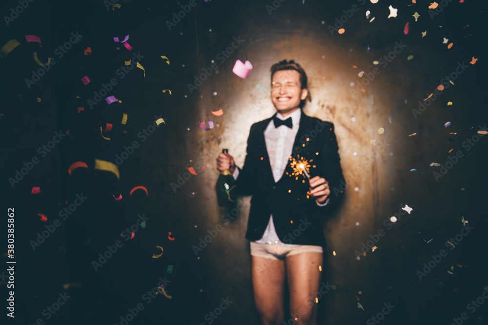 Men dressed in a suit and underpants with sparkler celebrating Men dressed in a suit and underpants with sparkler celebrating