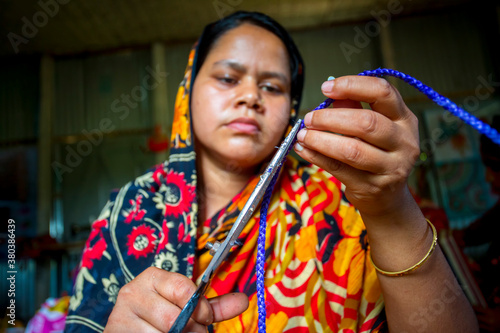 A woman crafts maker is making a showpiece home from the fibers of a banana tree at Madhupur, Tangail, Bangladesh. photo