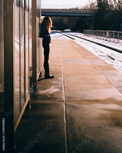 solitary woman waits for a train photo