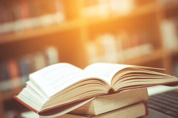 Book stack in the library and blurred bookshelf background for education. education background. back to school concept.