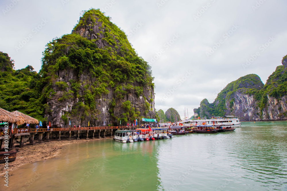 Tourist junks floating among limestone rocks at early morning in Ha Long Bay, South China Sea, Vietnam, Southeast Asia. Five images panorama