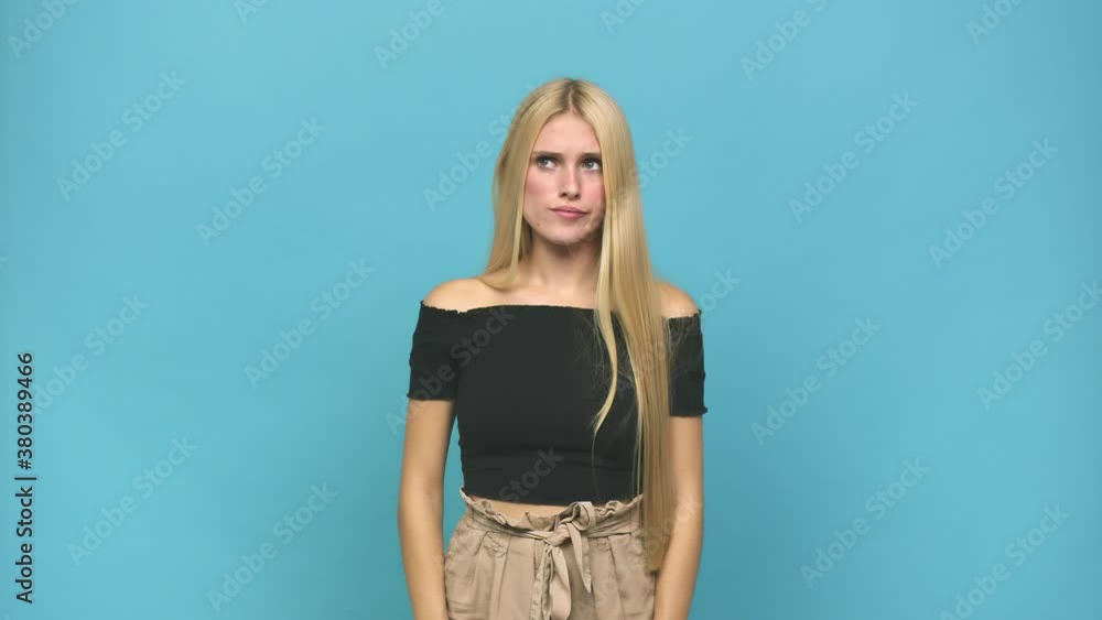 Young caucasian blonde woman confused, feels doubtful and unsure