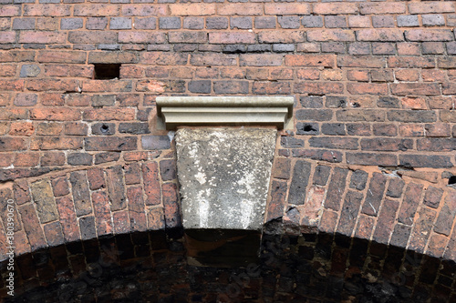 Old Weathered Brick Arch & Wall with Close Up of Keystone