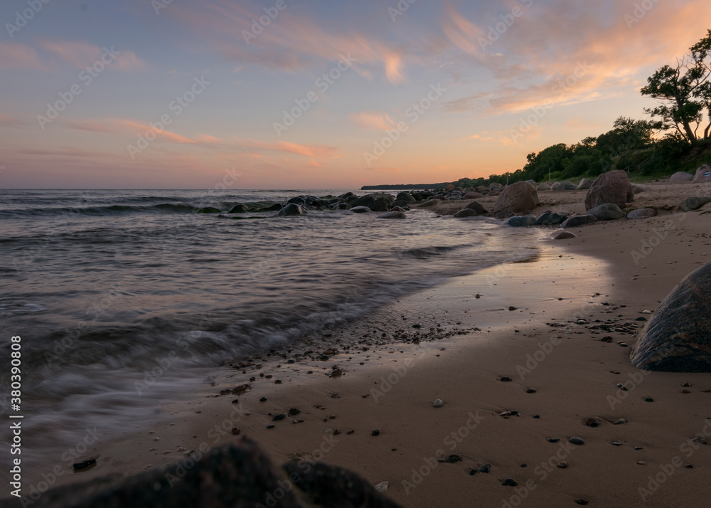 rocky sea shore before sunrise, dark stone silhouettes and colorful sky rocky sea shore before sunrise, dark stone silhouettes and colorful sky