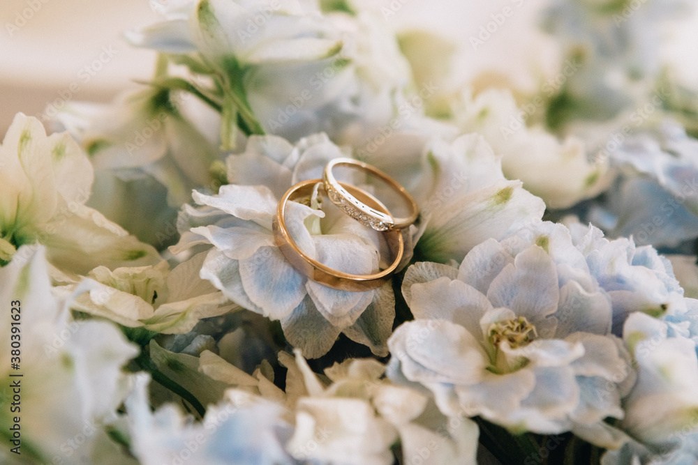 the bride holds a bouquet on the wedding day and exchanges wedding rings with the groom the bride holds a bouquet on the wedding day and exchanges wedding rings with the groom