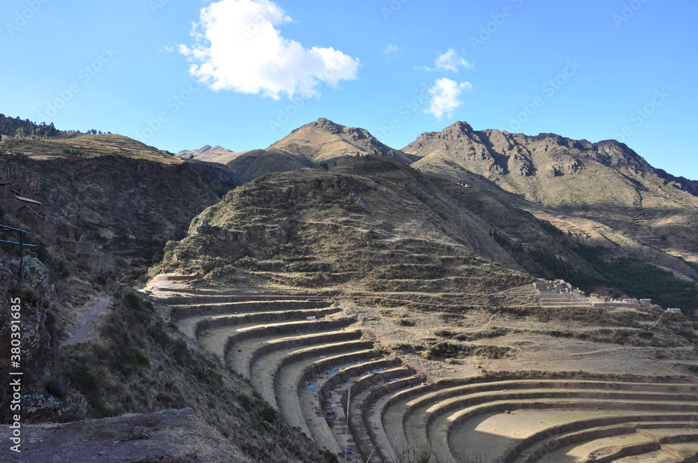 Dramatic landscape view of mountains, terraces and stone ruins in the Sacred Valley of Peru