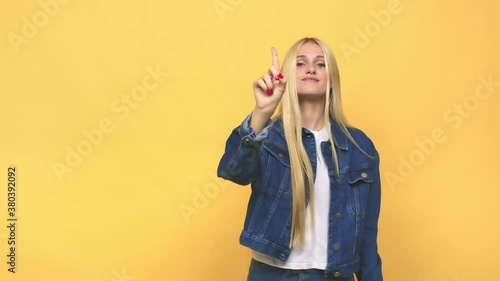 Young caucasian blonde woman showing number one with finger
