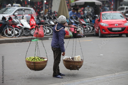 HANOI, VIETNAM - FEB 21: A small market for vendor in early morning in Hanoi, Vietnam on February 21, 2016. Vietnam florist vendor selling flowers on bicycle in small market or on street in Hanoi.