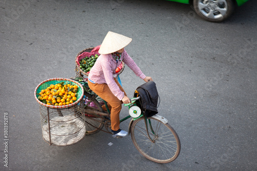HANOI, VIETNAM - FEB 21: A small market for vendor in early morning in Hanoi, Vietnam on February 21, 2016. Vietnam florist vendor selling flowers on bicycle in small market or on street in Hanoi.