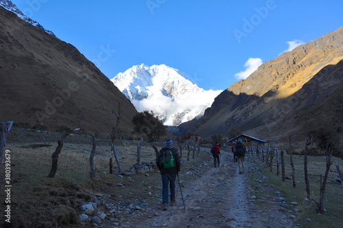 Hikers on the Salkantay trek in Peru, with snow capped mountains in the distance