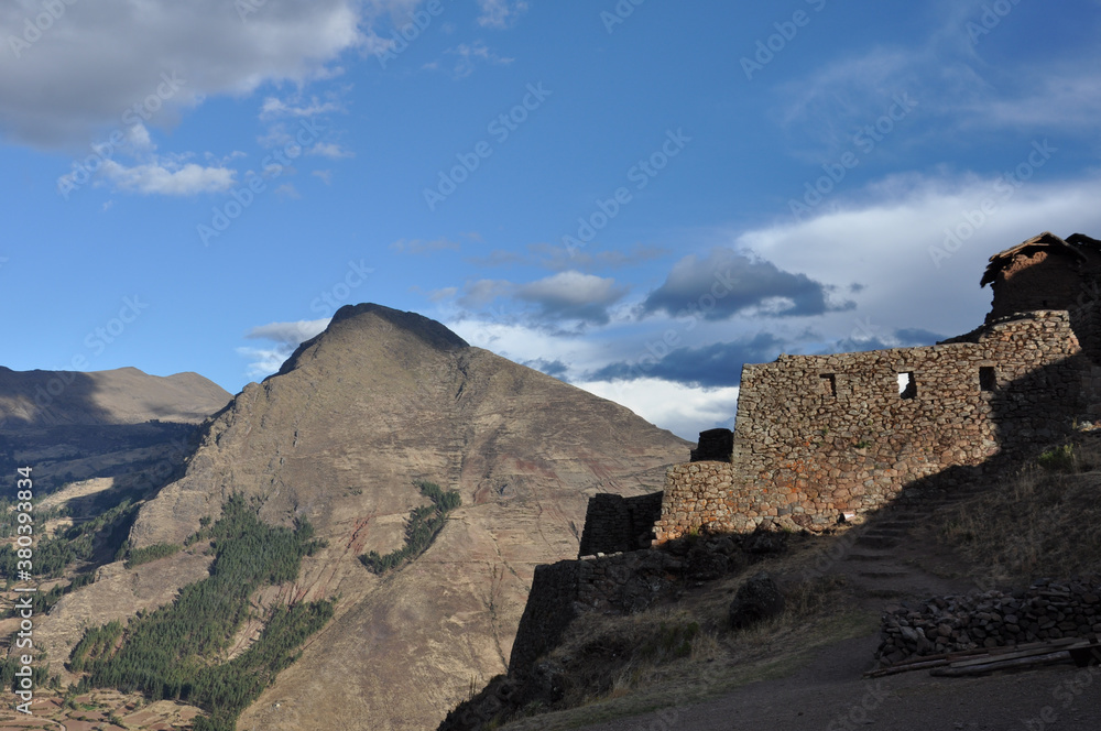 Stone ruins on a hilltop in the Sacred Valley of Peru on a cloudy day