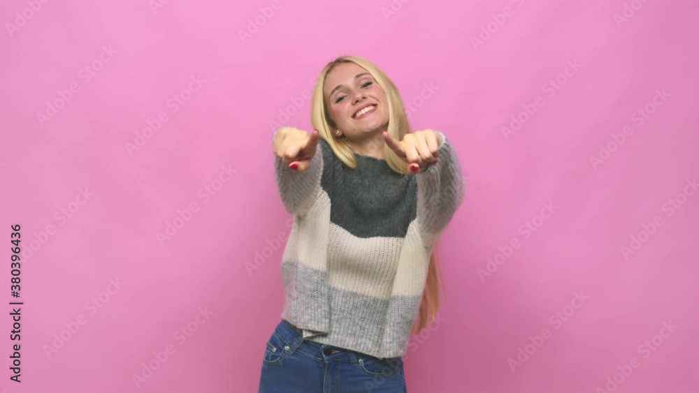 Young caucasian blonde woman cheerful smiles pointing to front