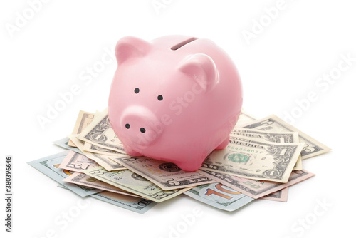 Pink piggy bank and US dollars notes