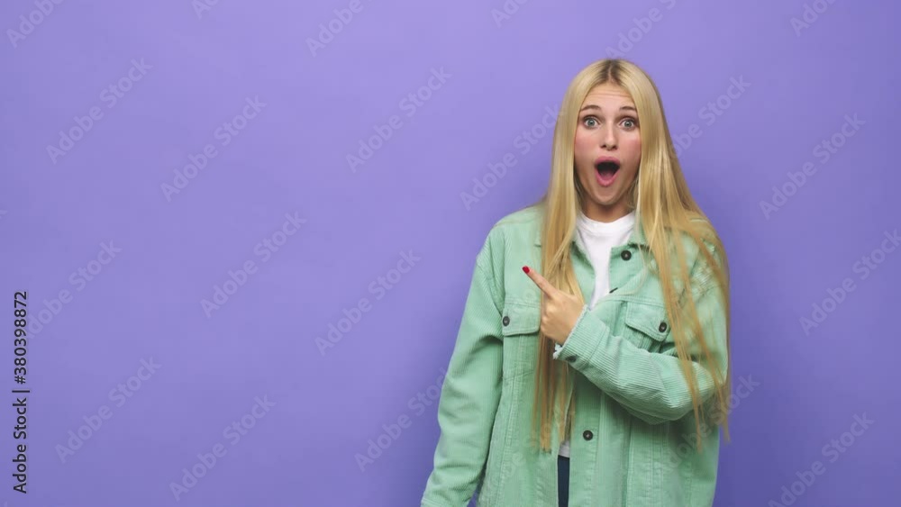 Young caucasian blonde woman pointing to the side Young caucasian blonde woman pointing to the side