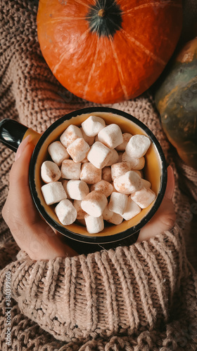 Cup of coffee with marshmallows on hand