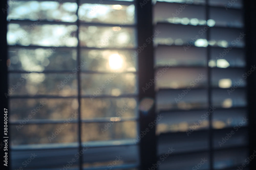Blurry shot of the sun coming through the shutters at dawn Blurry shot of the sun coming through the shutters at dawn