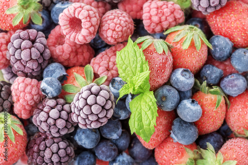 The frozen berries of raspberries, blackberries, blueberries, covered with hoarfrost.