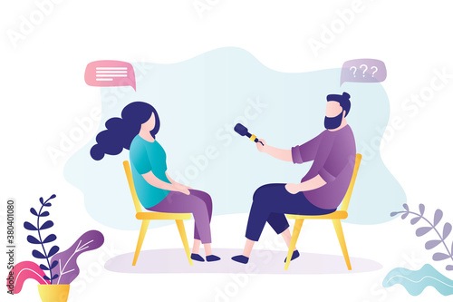 Journalist interviews business lady. Reporter holding microphone and give questions. Business People sitting on chairs.
