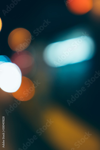 Car headlights and traffic lights at night, blurred focus photo