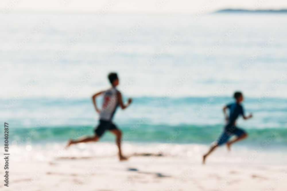 Kids running by the shore out of focus Kids running by the shore out of focus