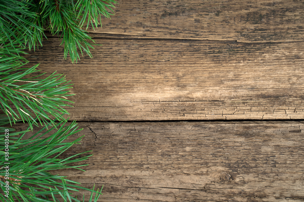 Christmas background made of fresh pine branches on a natural wooden background. Holiday background, top view. The concept of Christmas, New year. Christmas background made of fresh pine branches on a natural wooden background. Holiday background, top view. The concept of Christmas, New year.